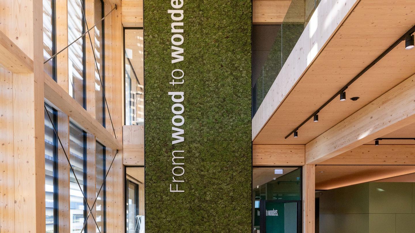 The new office building of HASSLACHER PREDING Holzindustrie, interior entrance with seating area Moss wall with logo