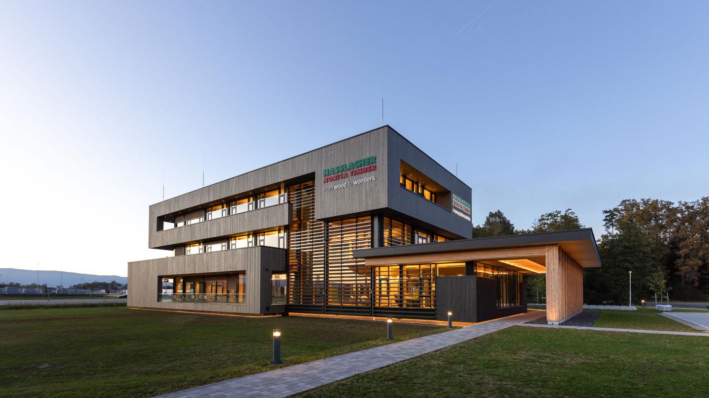 The new office building of HASSLACHER PREDING Holzindustrie, exterior at dusk