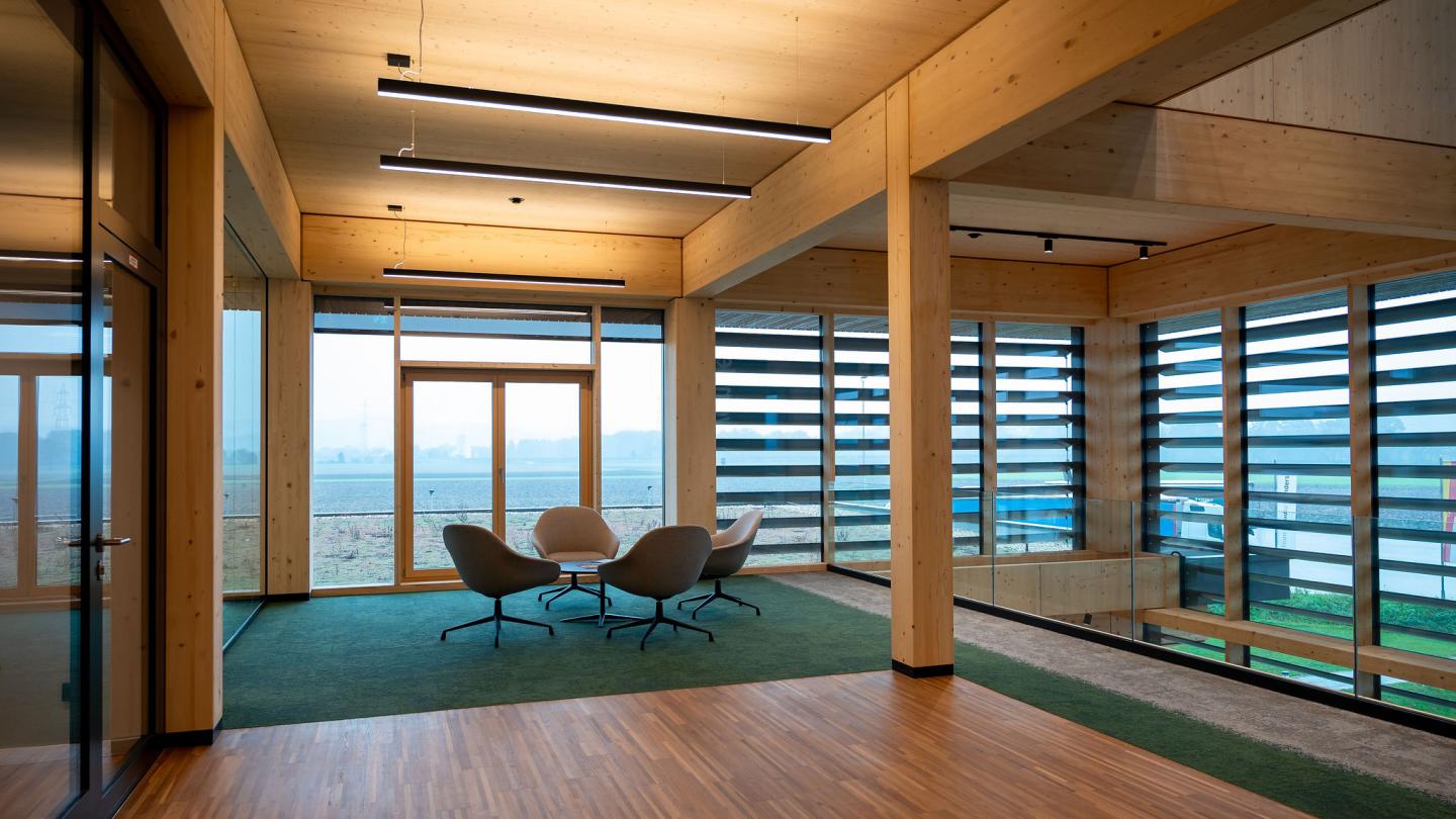 The new office building of HASSLACHER PREDING Holzindustrie, interior seating area with glass wall