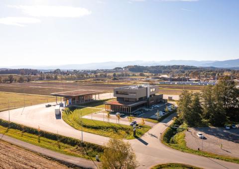 The new office building of HASSLACHER PREDING Holzindustrie, aerial view of office building, terminal and car park