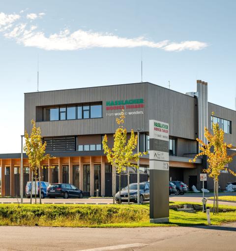 The new office building of HASSLACHER PREDING Holzindustrie, driveway and car park with cars
